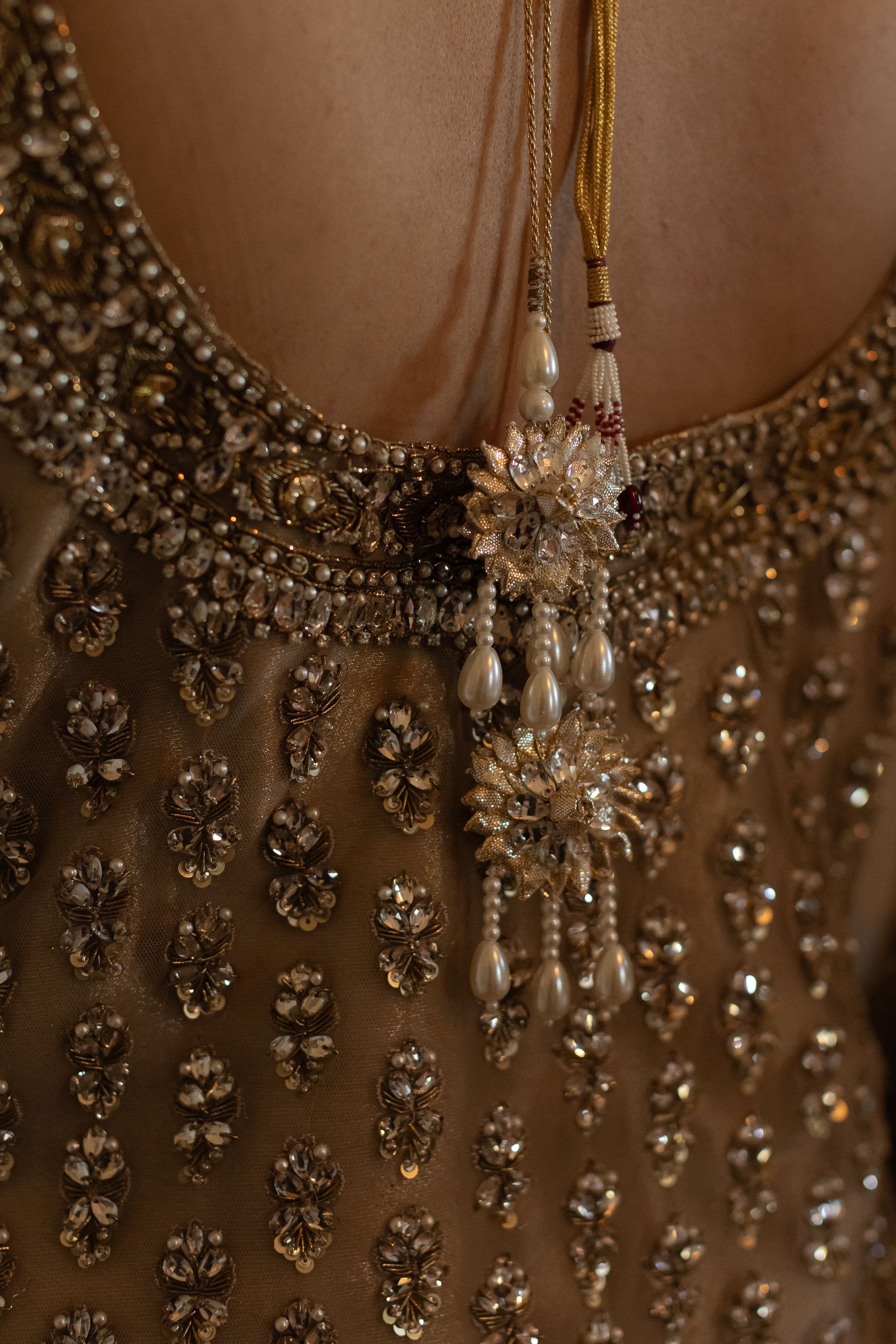 Gold beaded dress with pearl and crystal jewelry.