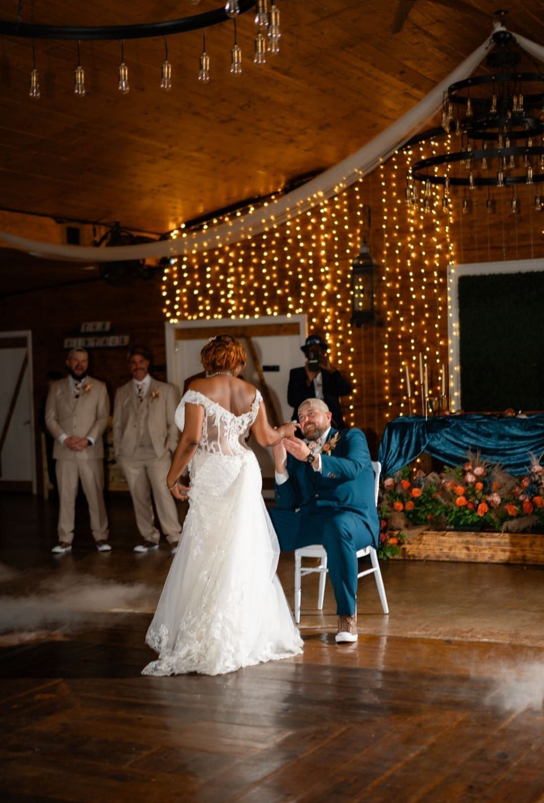 A bride and groom are dancing their first dance at their wedding reception.