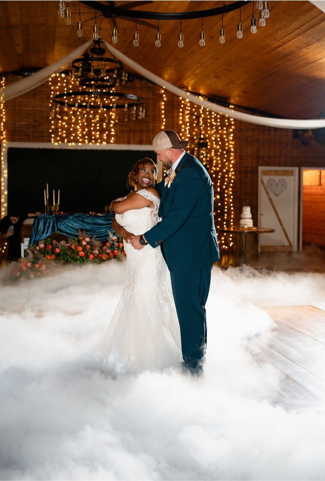 A bride and groom are dancing in the clouds at their wedding reception.