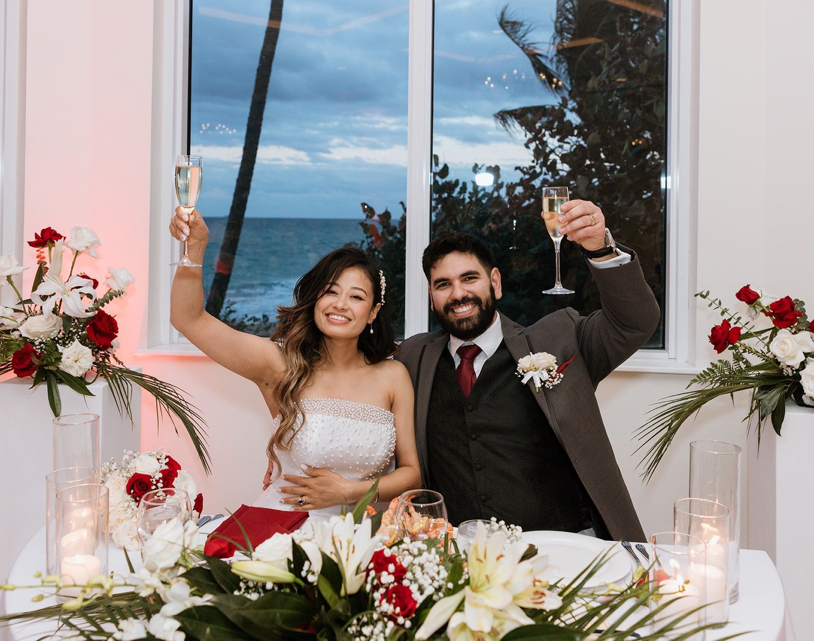 A bride and groom are toasting with champagne at their wedding reception.