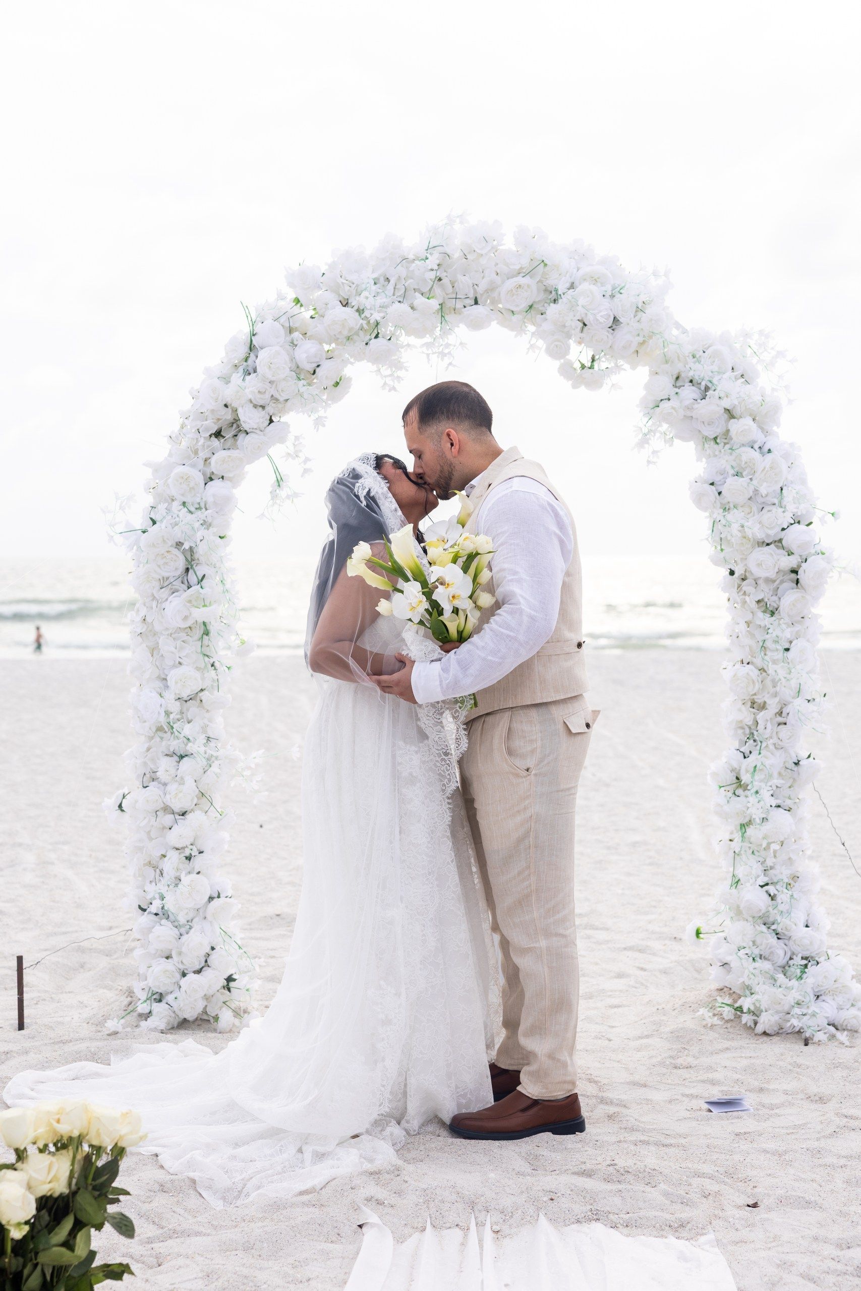 white floral wedding arch on the beach in st pete wedding