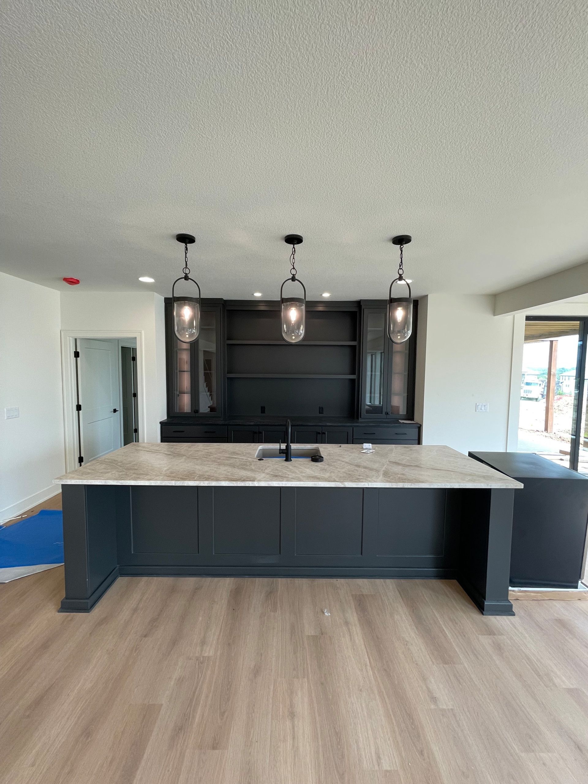 A kitchen with a large island and a sink