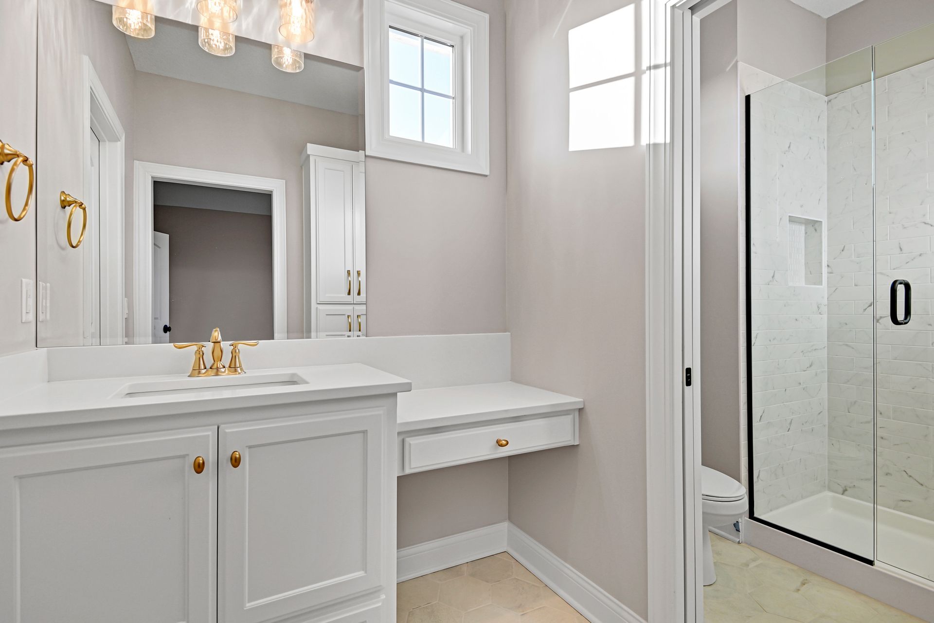 A bathroom with a sink , mirror , toilet and walk in shower.