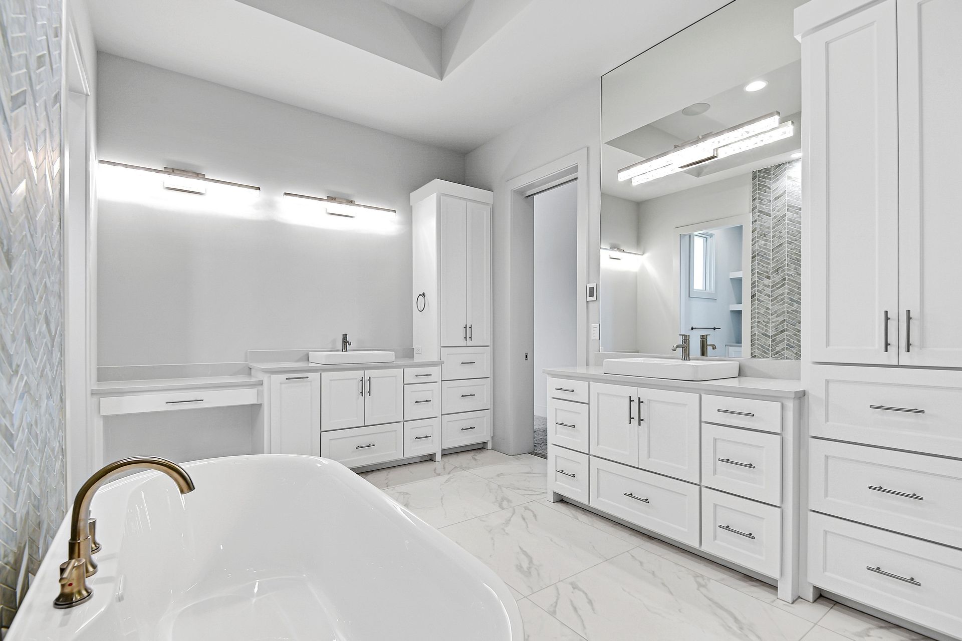 A bathroom with a bathtub , sinks , cabinets and mirrors.