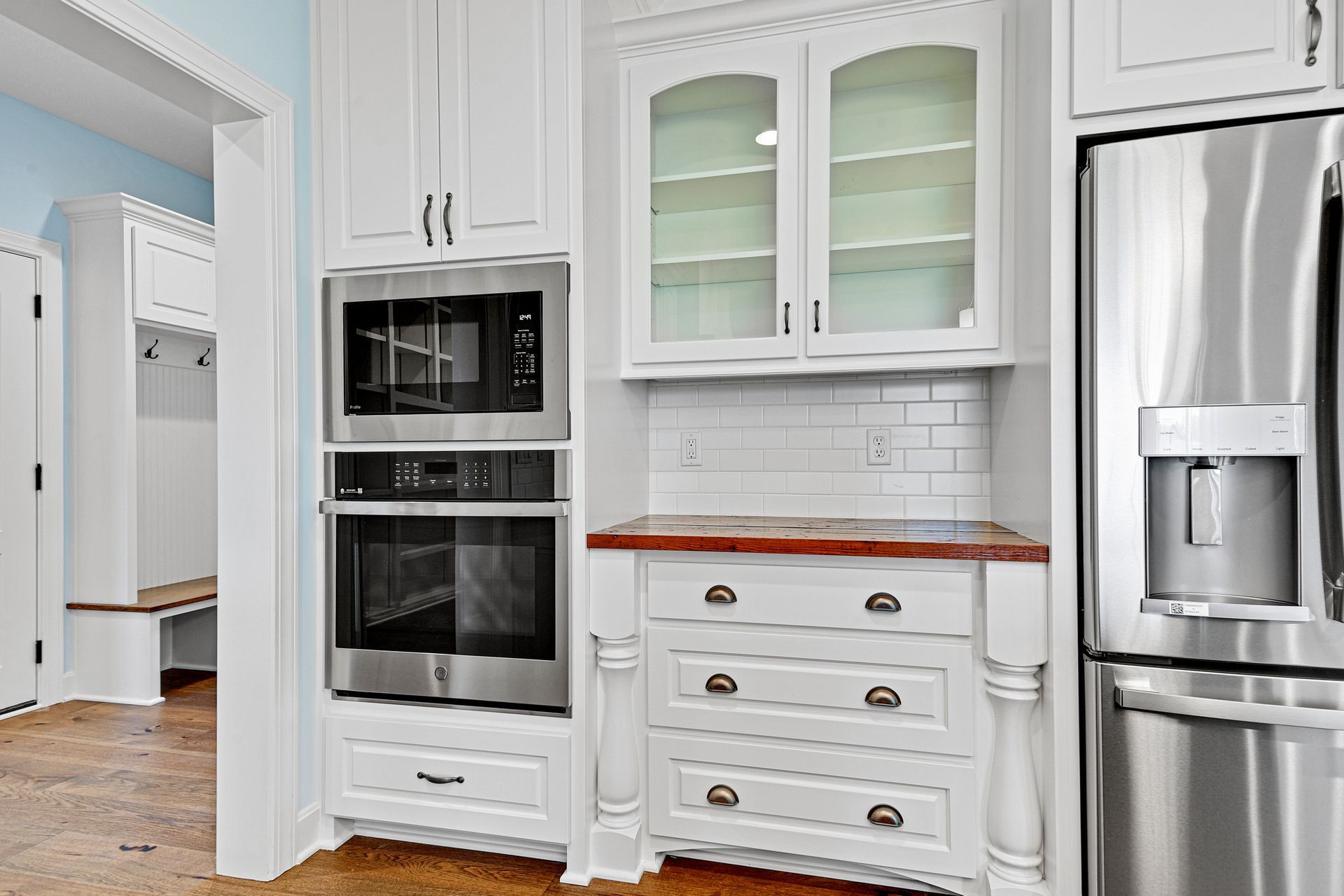 A kitchen with white cabinets and stainless steel appliances.