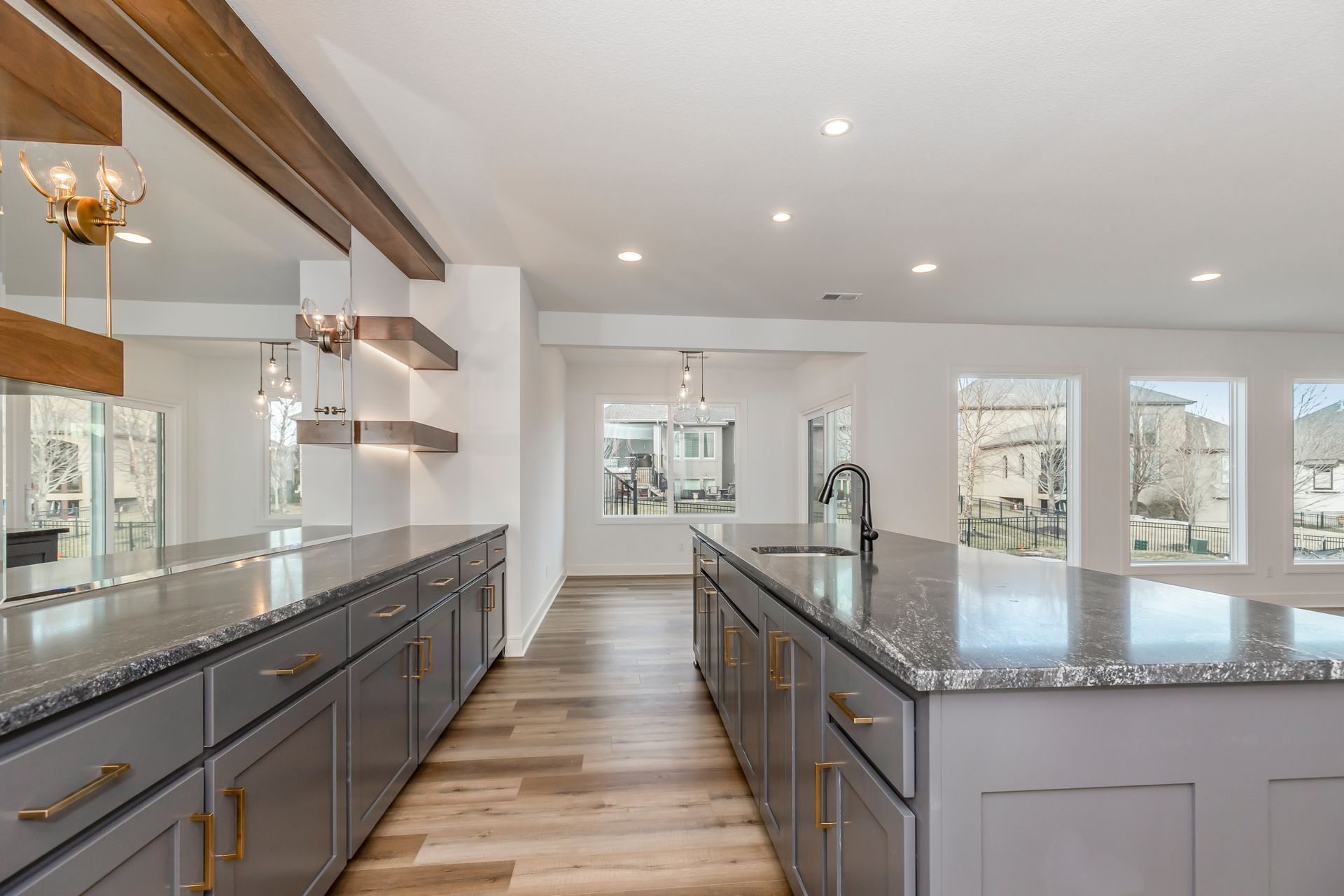 A kitchen with a large island and granite counter tops.