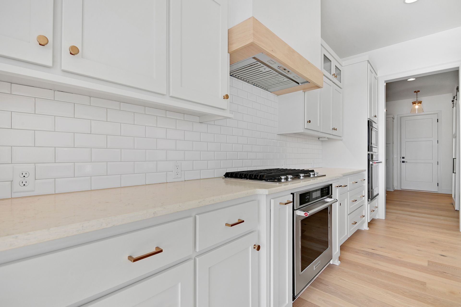 A kitchen with white cabinets and stainless steel appliances.