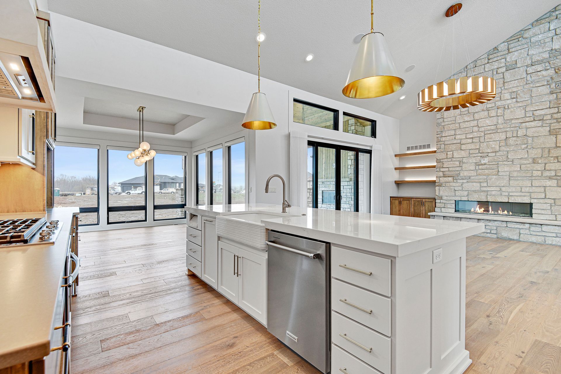 A kitchen with a large island and stainless steel appliances.