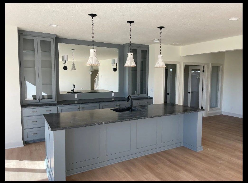 There is a large island in the middle of the kitchen.