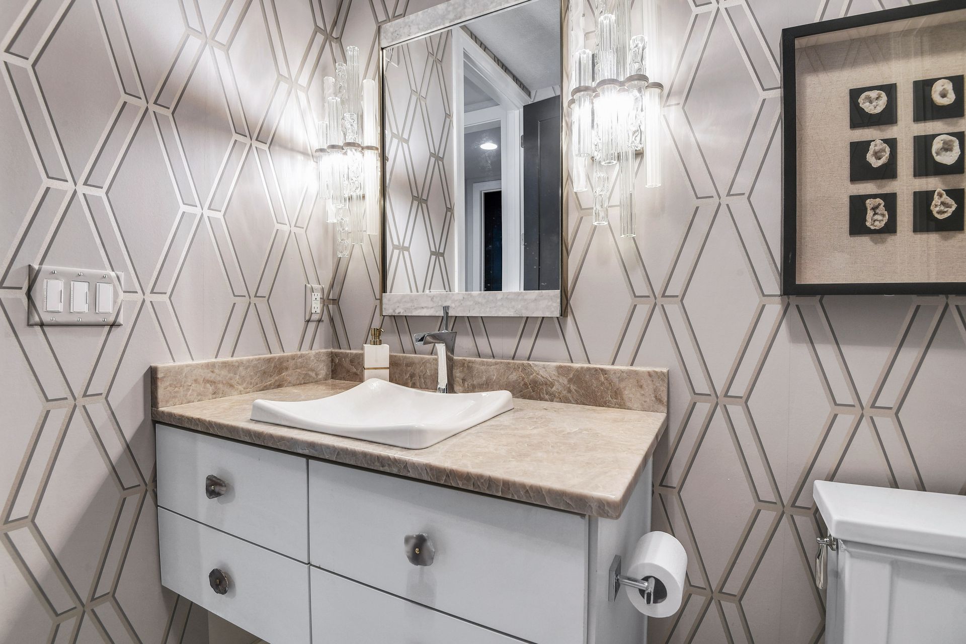 A bathroom with a sink , mirror and toilet.