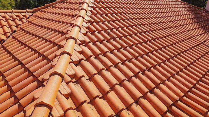 Orange terracotta roof tiles with a central ridge line, viewed from above