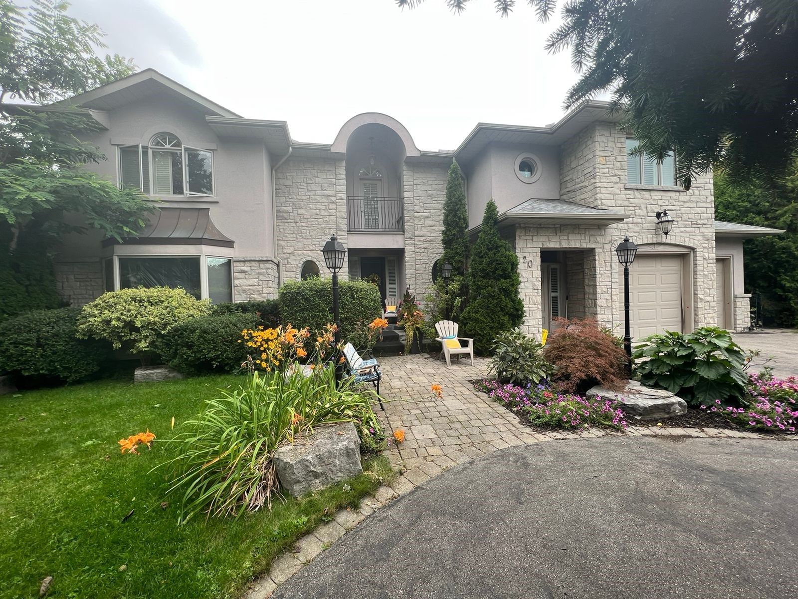 a large house with a lot of plants in front of it .