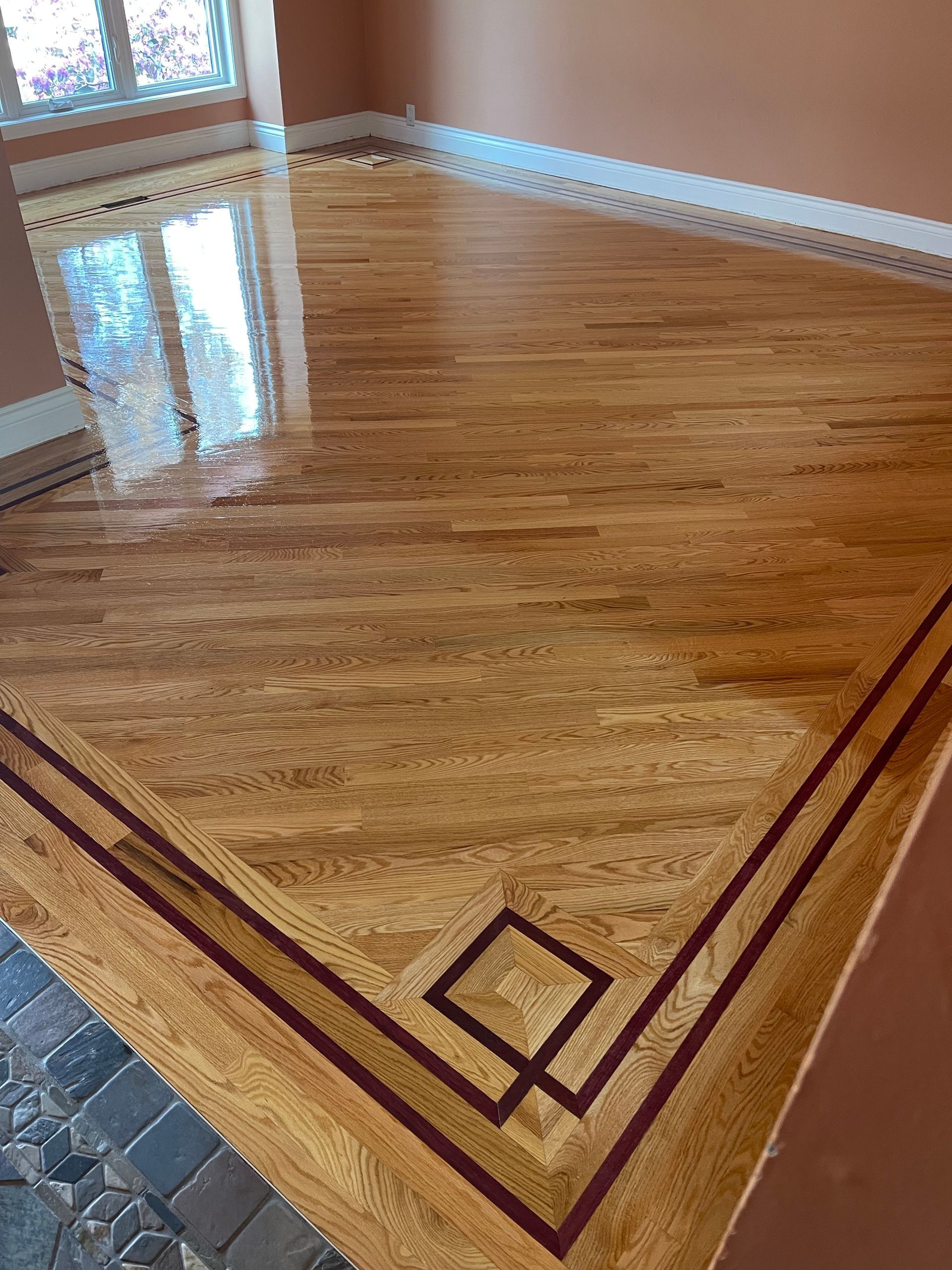 a wooden floor with a geometric design on it in a living room .