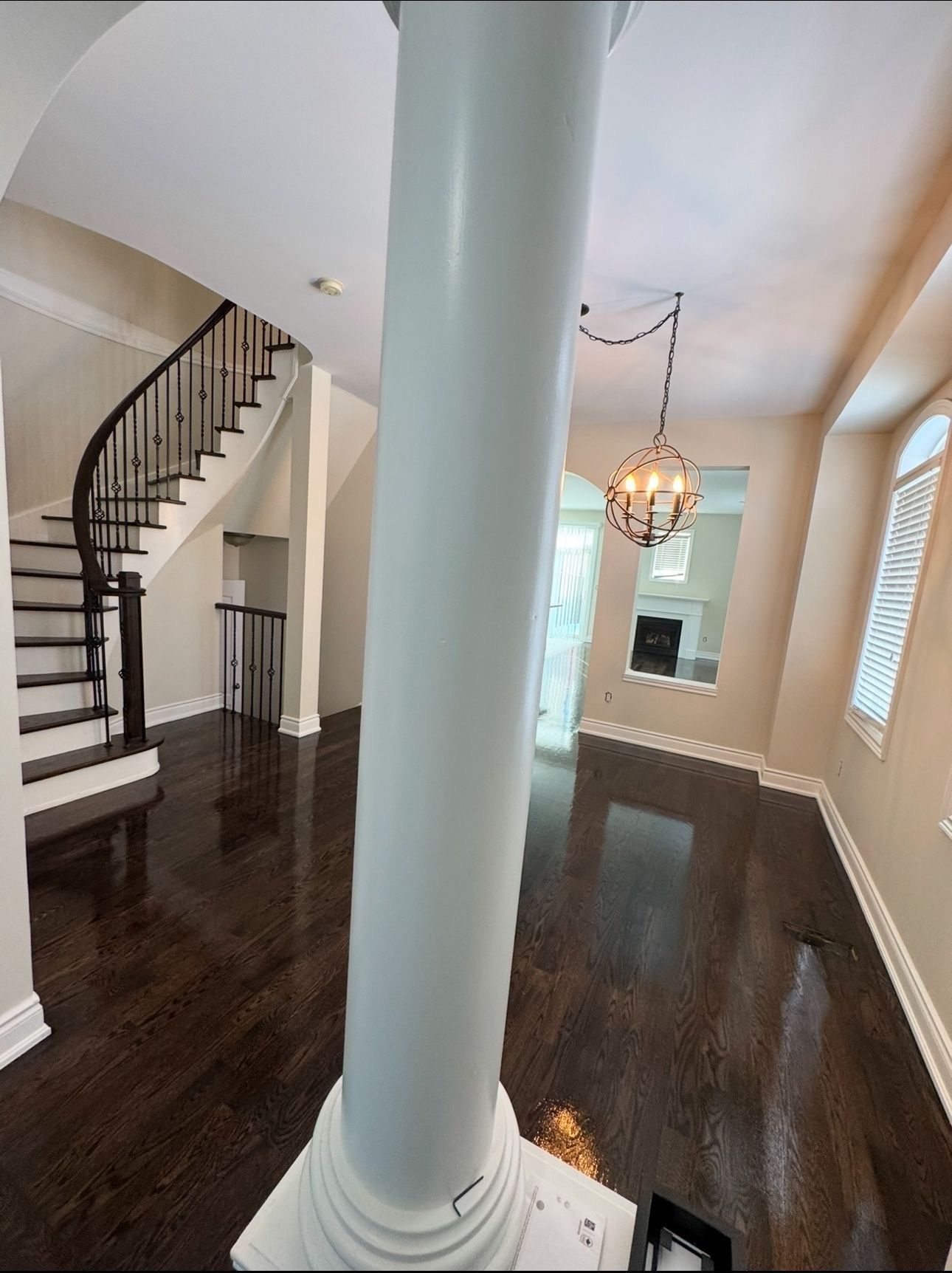 a wooden staircase with a wrought iron railing in a house .
