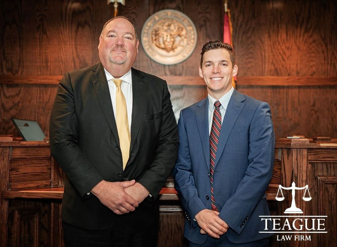 Two men in suits and ties are standing next to each other in a courtroom.