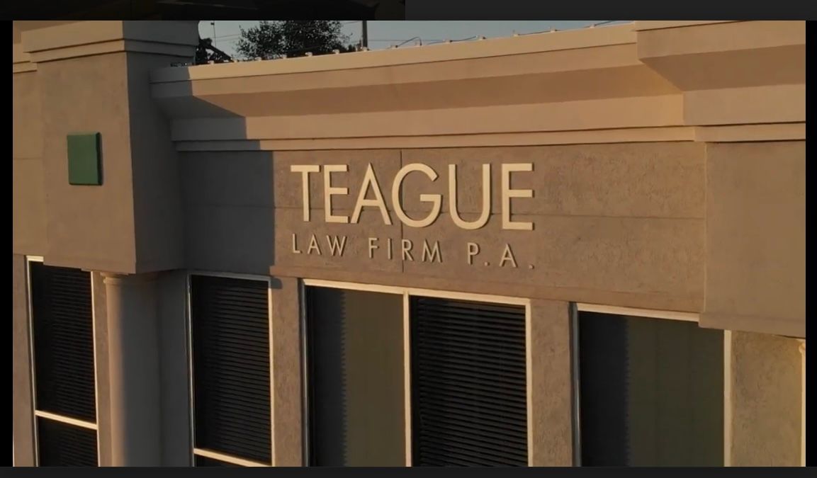 A building with a sign that says teague law firm pa