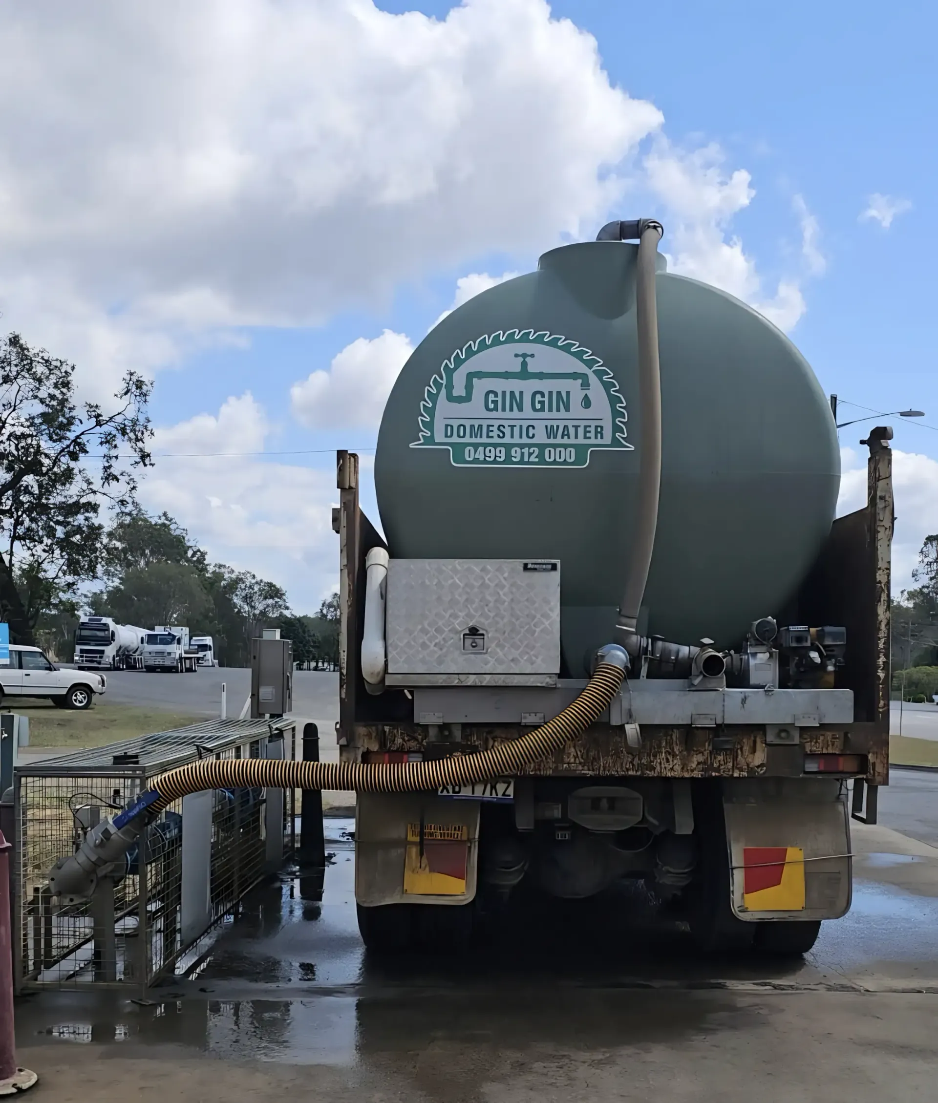 Tan Water Tank Next to A Brick Wall — Gin Gin Domestic Water Supplies in Bucca, QLD