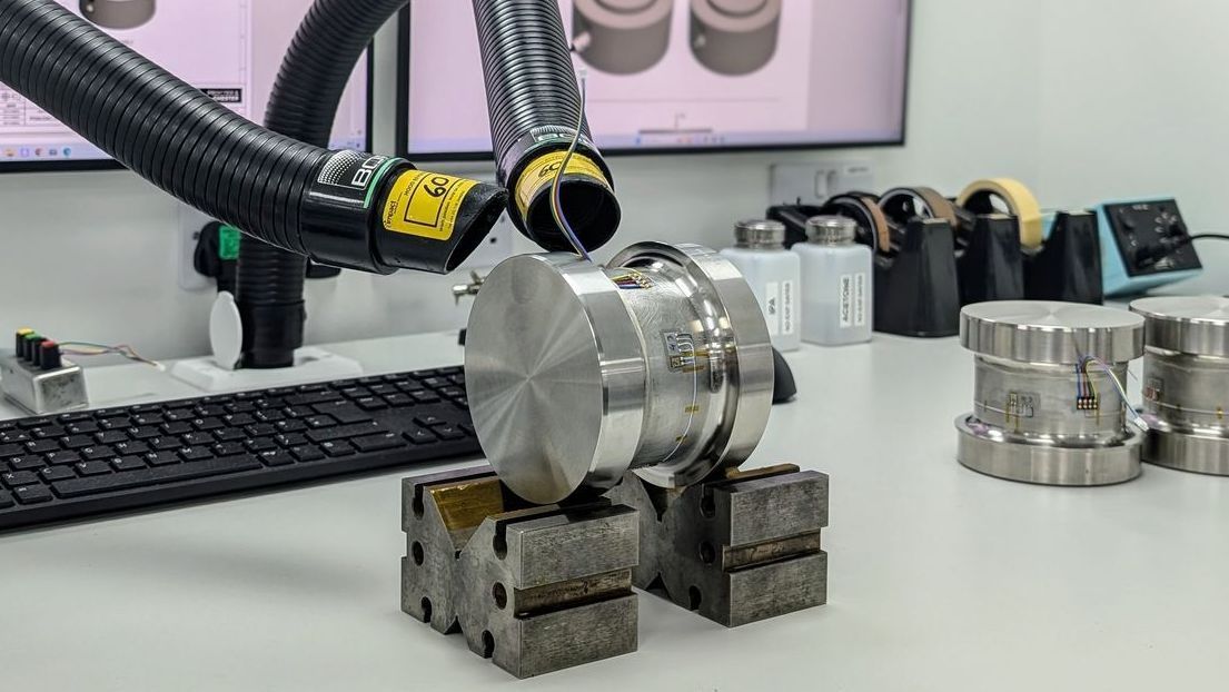 A load cell being manufactured and strain gauged.