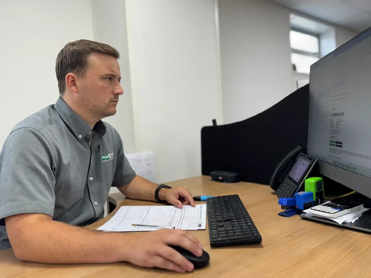 Chris Porter, Sales Executive from Procter & Chester Measurements working at his desk.