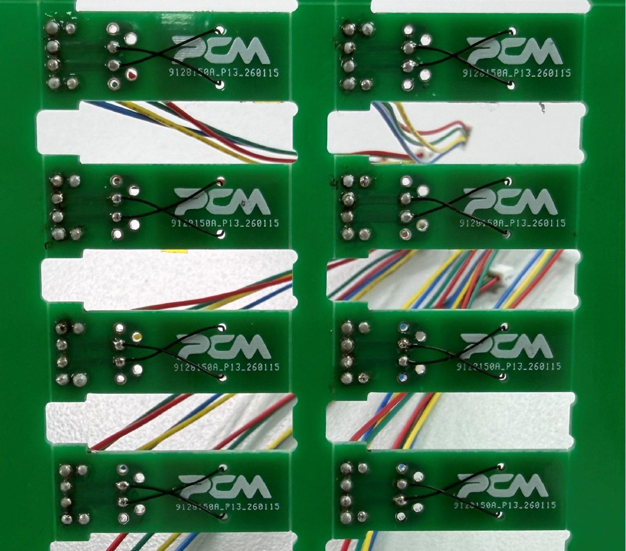 Green PCM branded chips with multicoloured wires protruding from them.