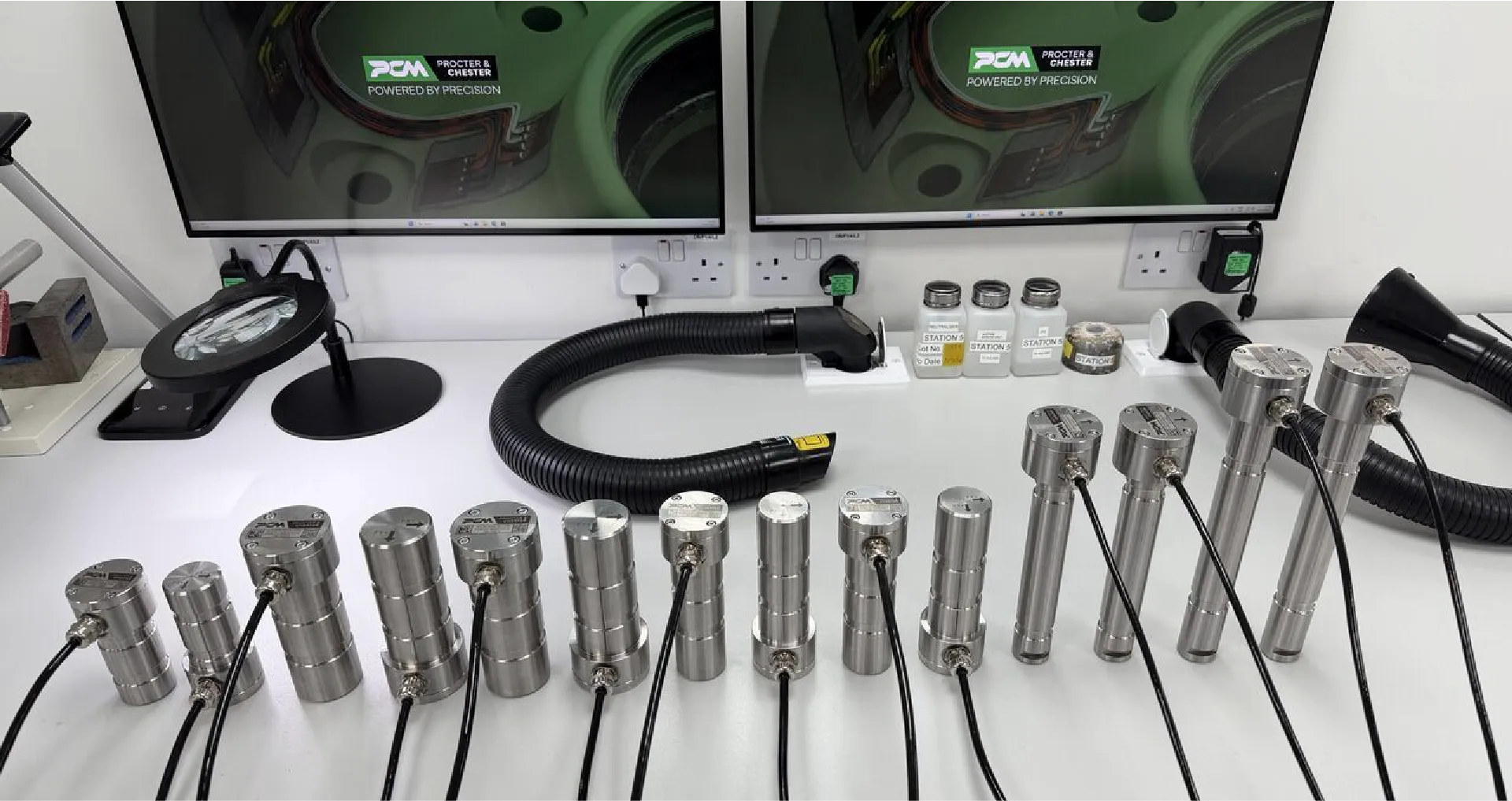 Rows of custom machined tension link load cells from PCM