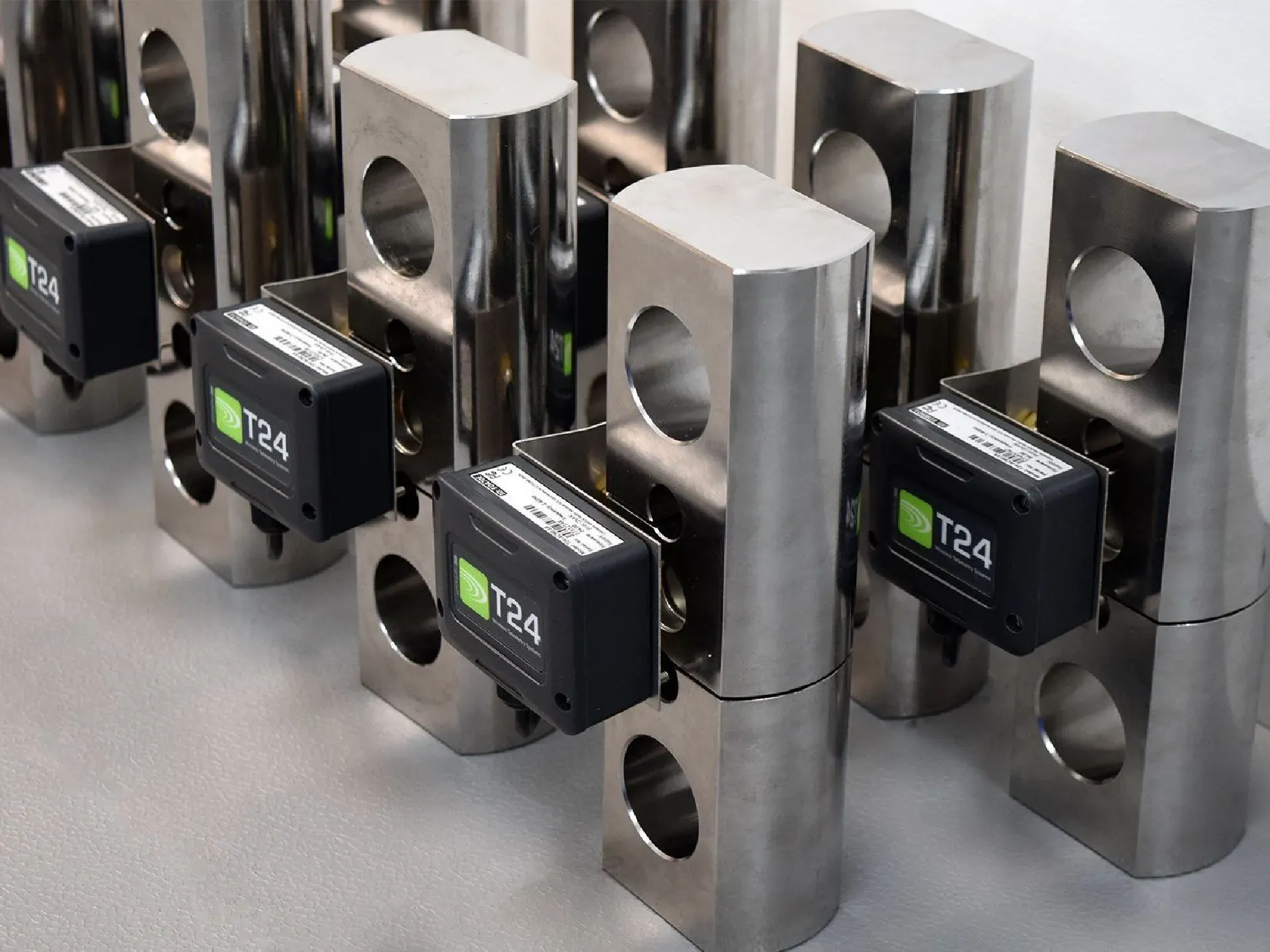 Rows of custom machined tension link load cells from PCM