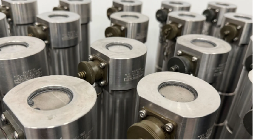 Rows of custom machined tension link load cells from PCM