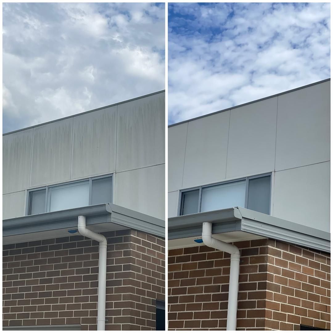 A before-and-after comparison of a building exterior, showing the removal of dark vertical streaks from gray metal siding — South Coast Pressure Washer in Warilla, NSW