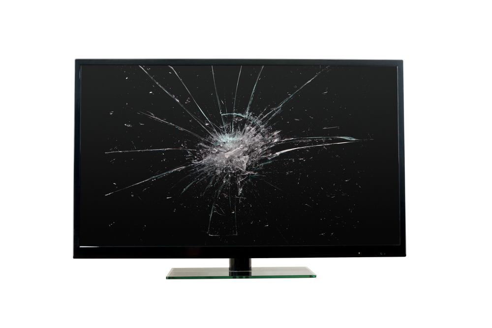 A computer monitor with a broken screen on a white background.