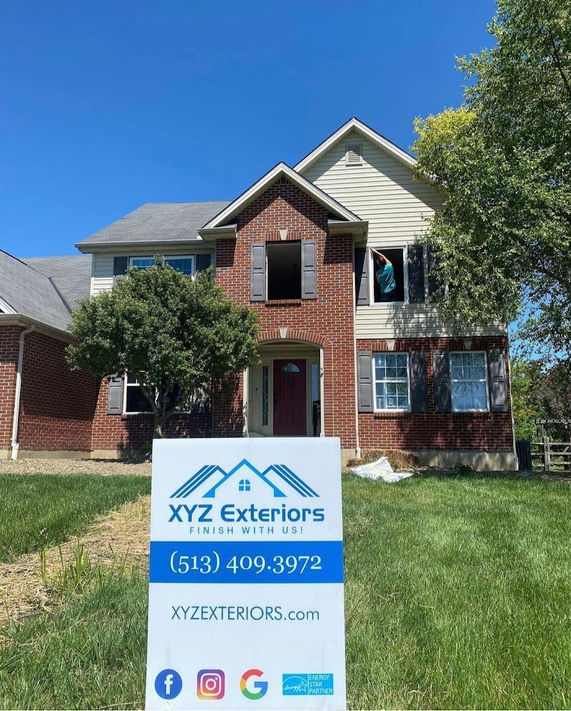 A house with a sign in front of it that says xyz exteriors