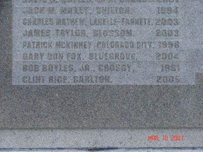 A close up of a gravestone with the names of people written on it