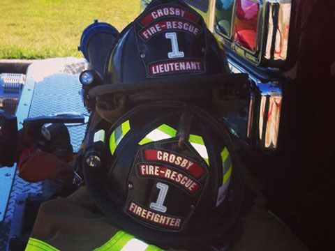 A firefighter 's helmet has the number 1 on it