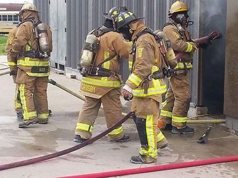A group of firefighters are working on a fire during a training exercise