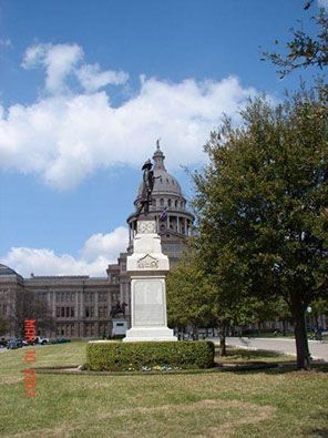 A large building with a statue in front of it