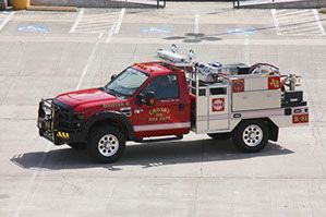 A red and white fire truck is parked in a parking lot.