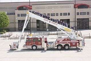 A red and white fire truck is parked in front of a building