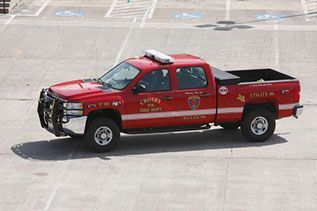 A red chief's vehicle is parked in a parking lot.