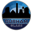 A circular logo with a blue sunburst background featuring a black city skyline silhouette, labeled