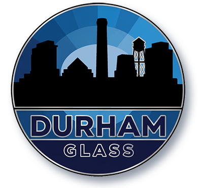 Durham Glass logo with blue city skyline and black circular emblem
