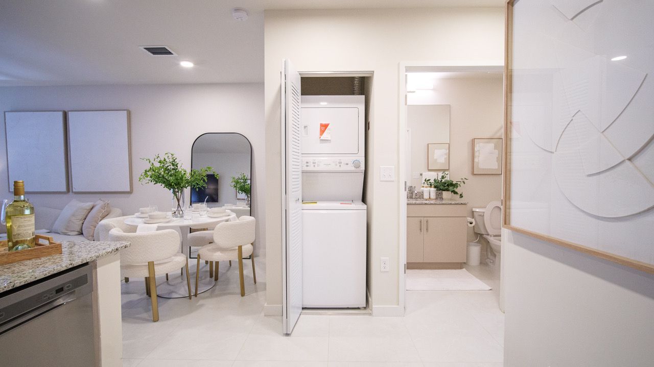 There is a washer and dryer in the closet in the living room at Atlantica at Dania Beach apartments in Dania Beach, FL.