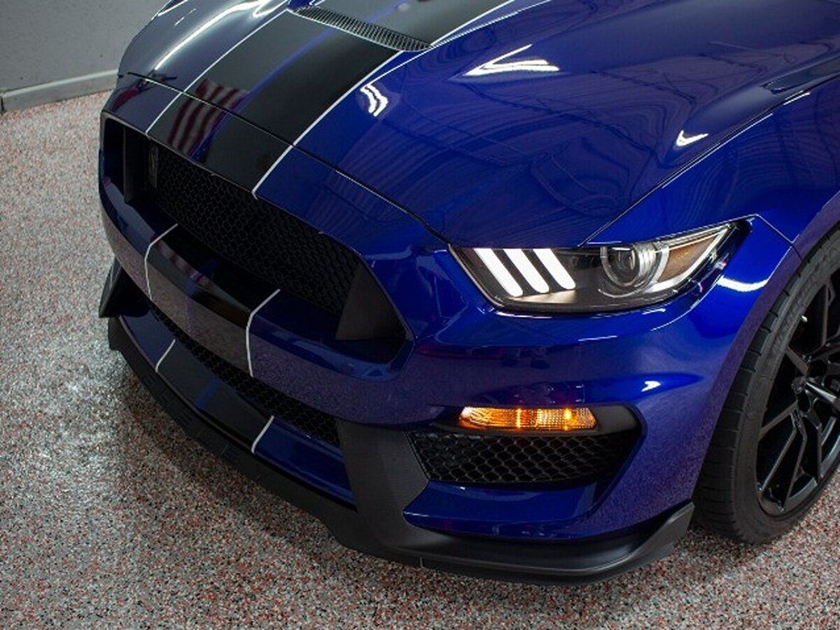Blue Ford Mustang Shelby GT350 with black racing stripes.