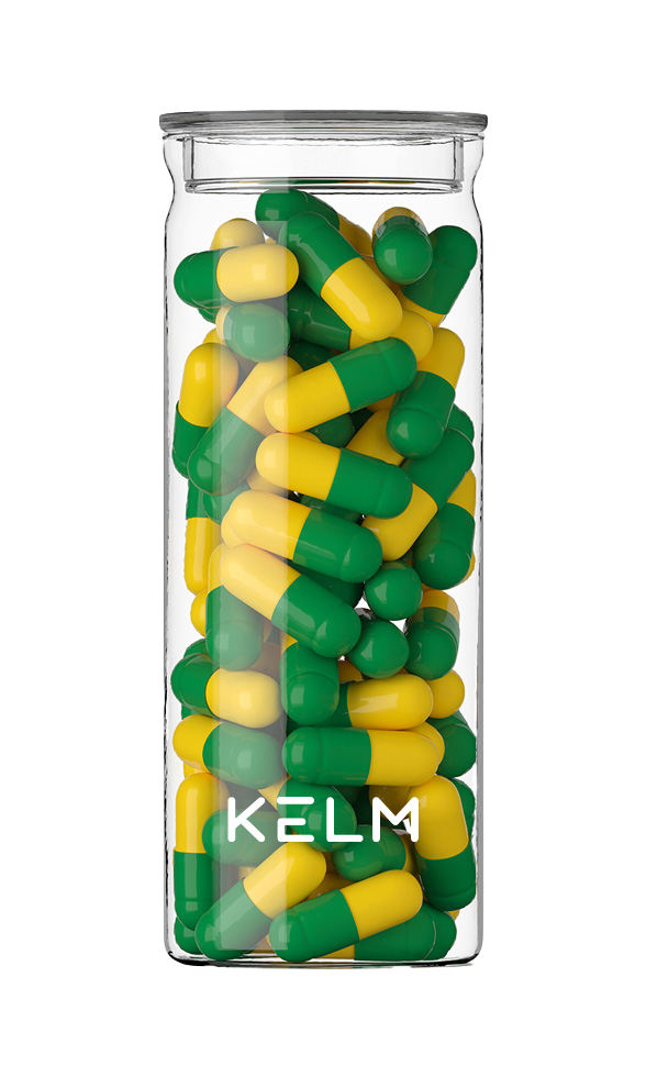 A glass jar filled with green and yellow capsules.