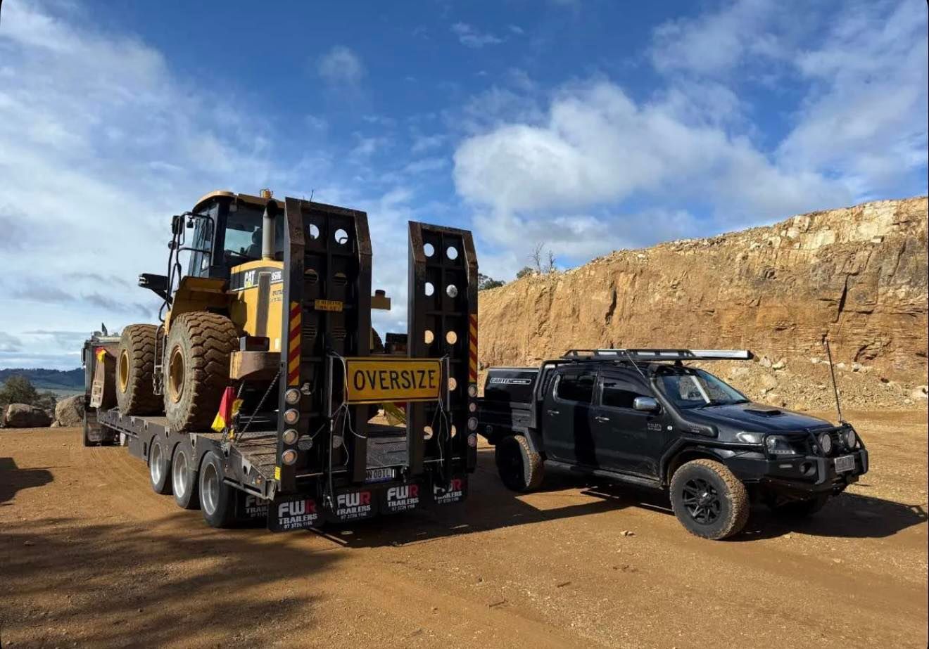 A Heavy Construction Vehicle Sits on A Flatbed Trailer — CartEX in Mornington, TAS