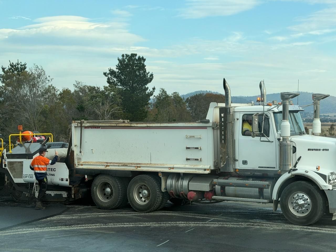 Workers Loading Asphalt into a White Dump Truck — CartEX in Mornington, TAS