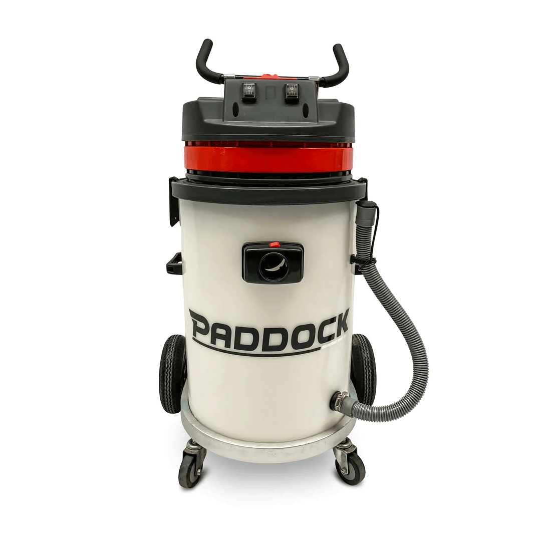 Red and black Prodoc vacuum cleaner with wheels and hose on a white background