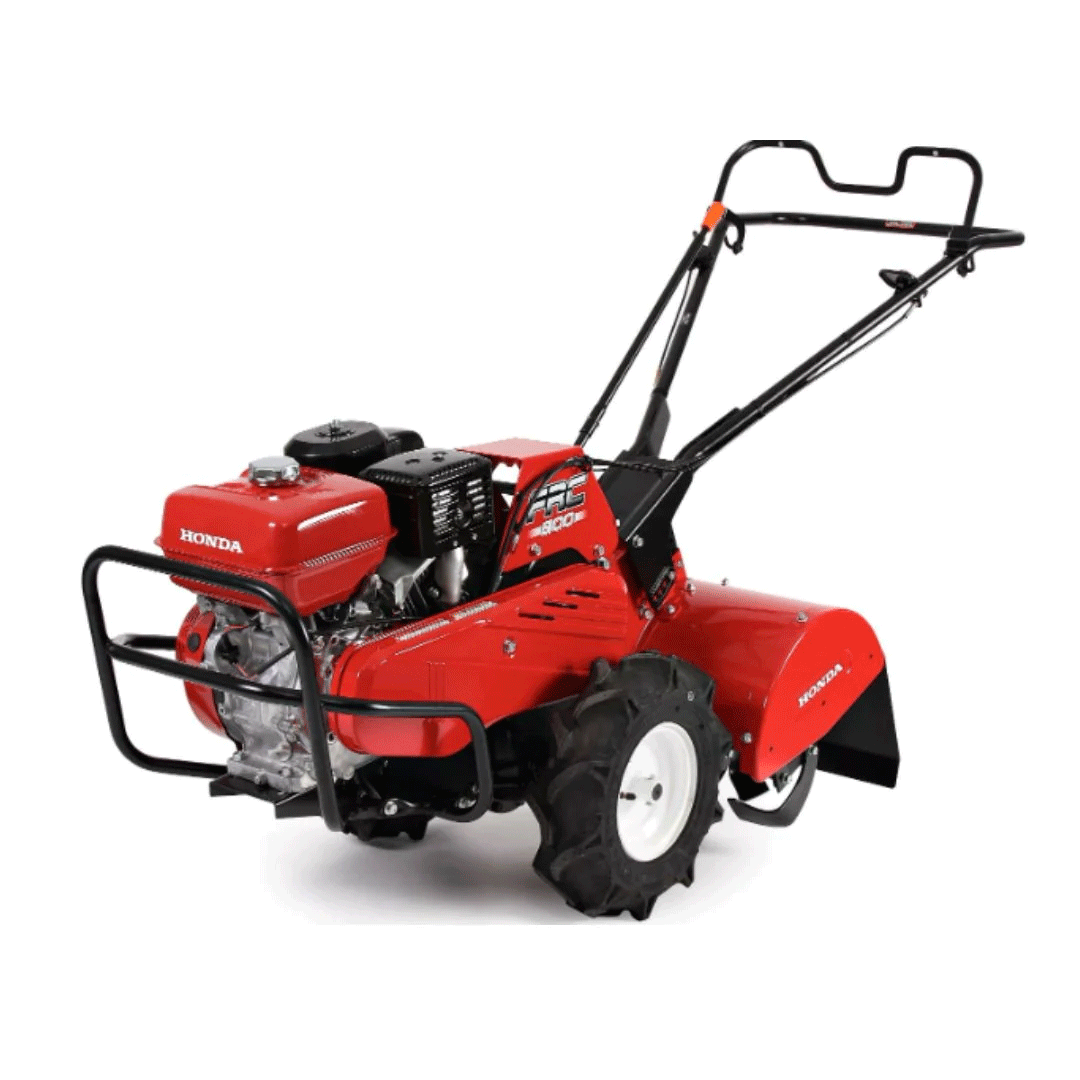 Red Honda tiller with black handles and wheels on a white background