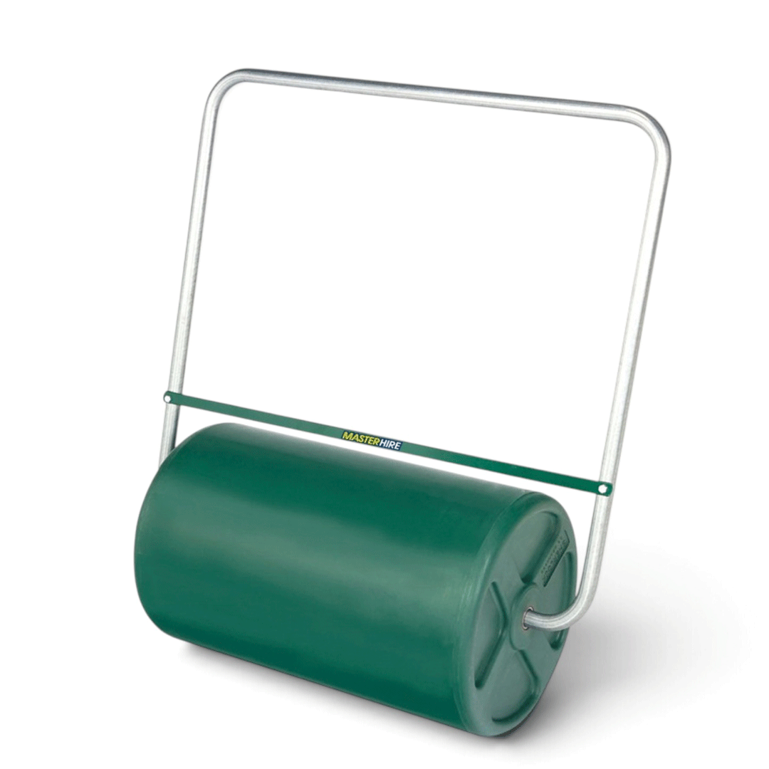 Green lawn roller with metal handle on a white background