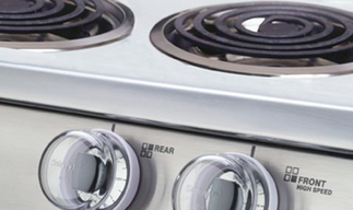 A close up of a stove with the front and rear knobs visible
