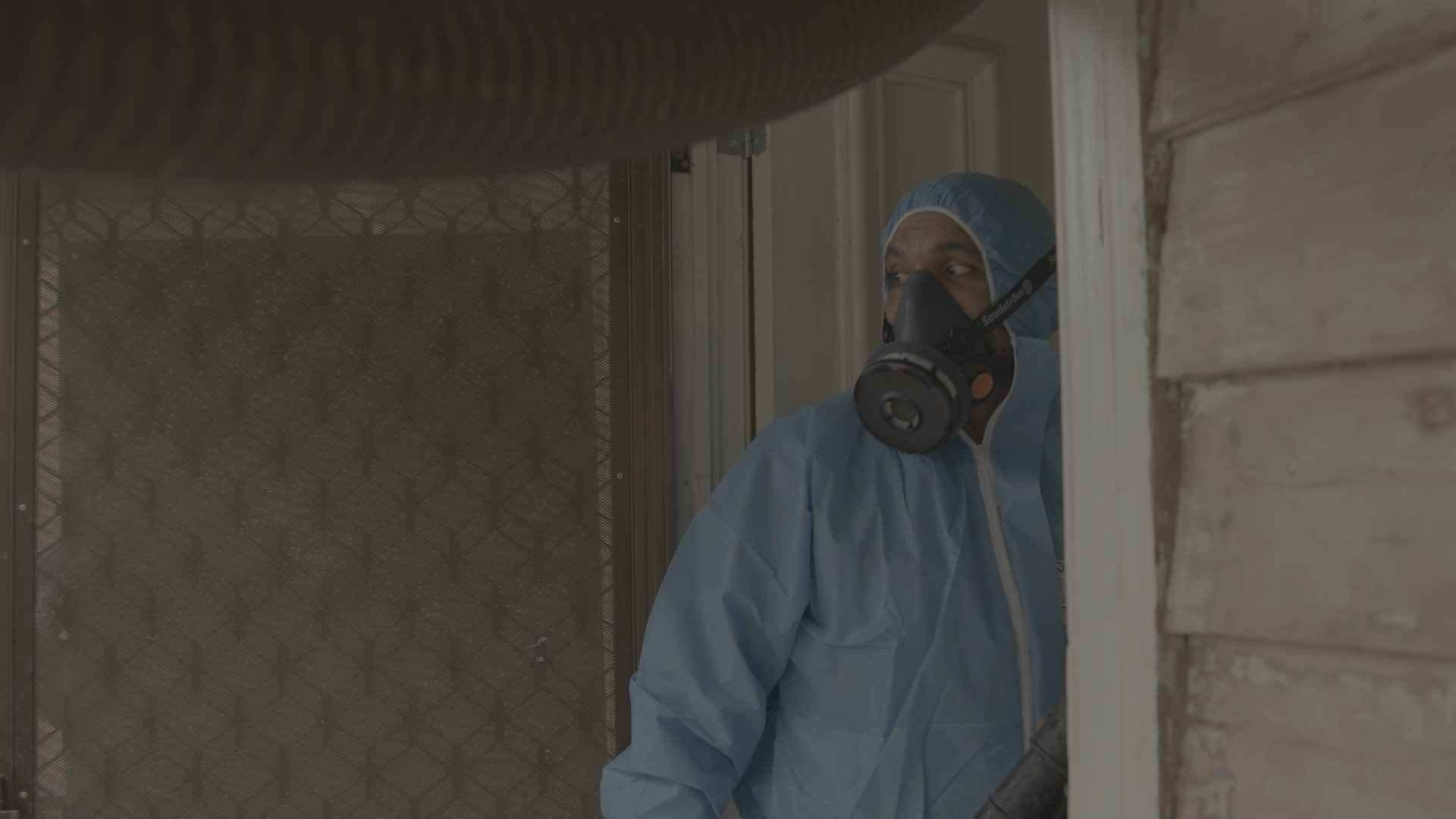 Ceiling Alert technician in protective gear arriving at a job
