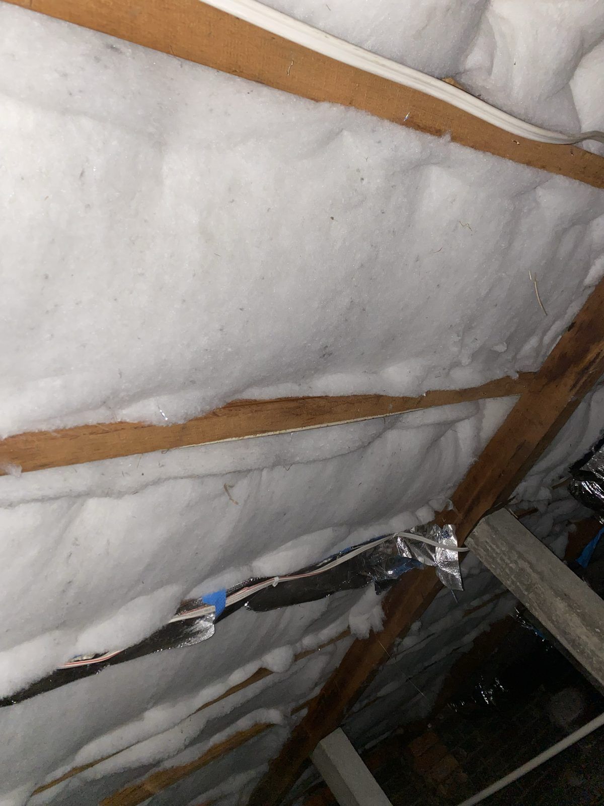 Polyester underfloor insulation batts fitted between floor joists in a Melbourne home